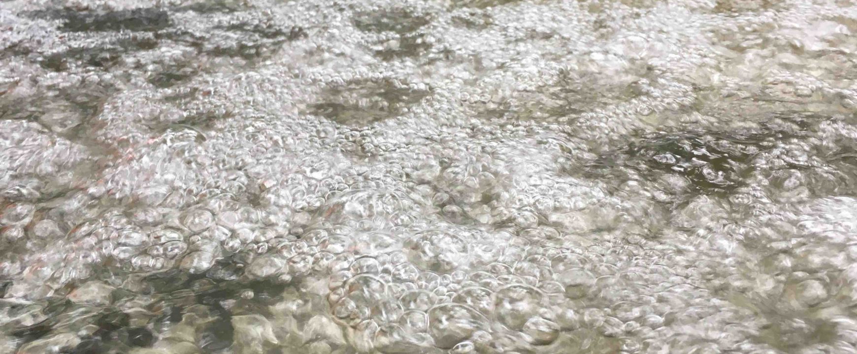 Bubbles breaking surface tension to form a barrier